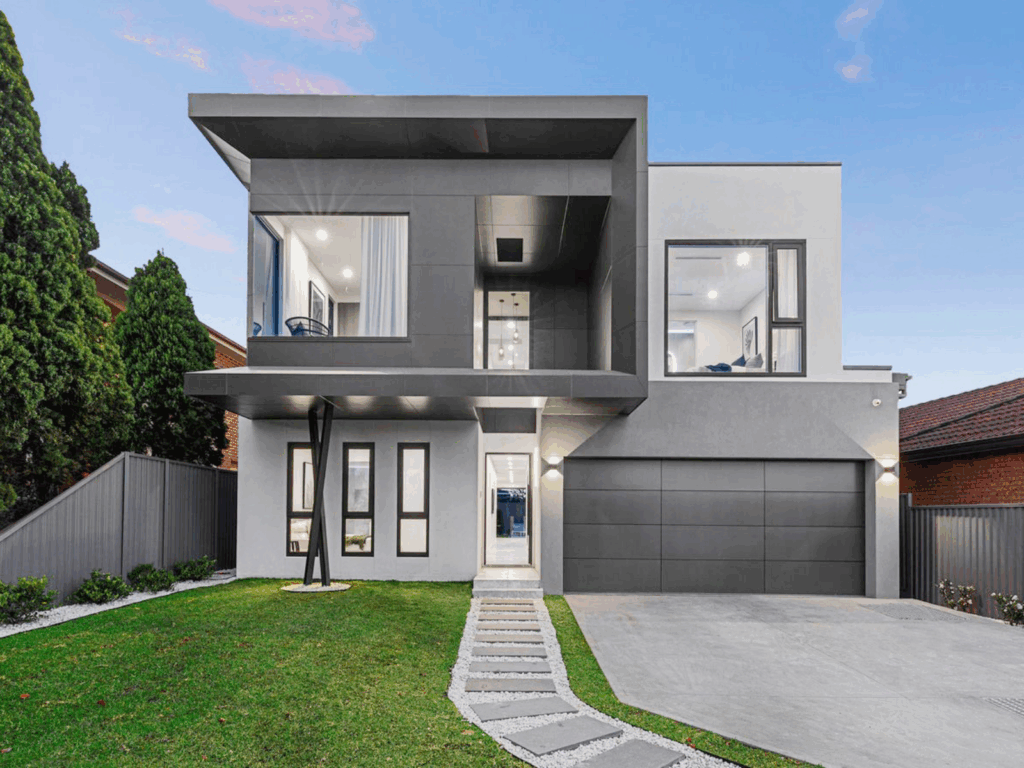 A modern two level house with sharp lines, large windows, and a clean facade