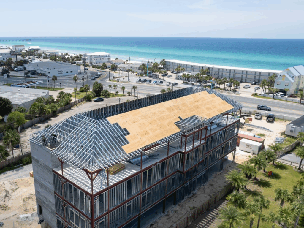A multi level steel framed building under construction near the beach