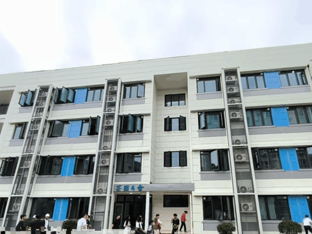 A multi storey dormitory with white exterior walls and many windows