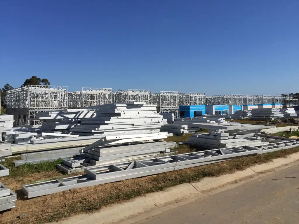 Multi-unit building site with light gauge steel framing under construction.