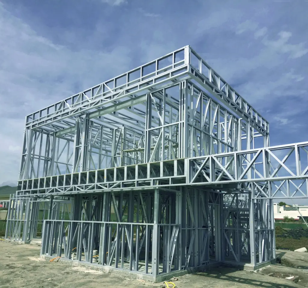 Steel framing structure for a multi-level building under construction under clear sky.
